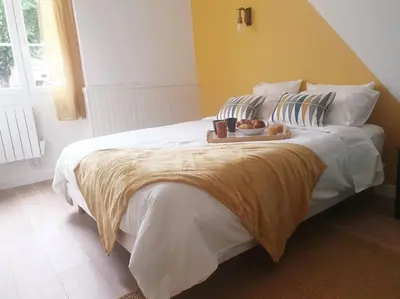 a bedroom with a bed with a tray of food on it at Escapade détente au cœur de Pamiers in Pamiers