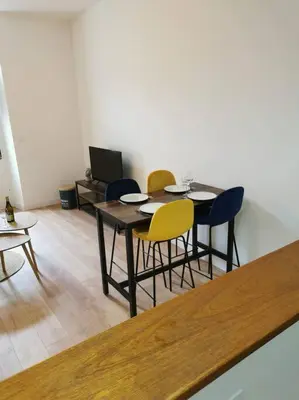 a dining room with a table and four chairs at Escapade détente au cœur de Pamiers in Pamiers