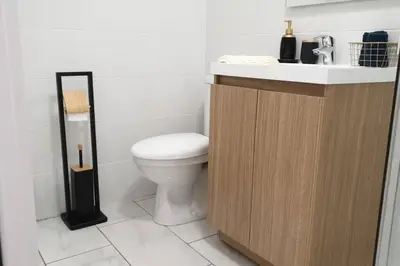a bathroom with a white toilet and a sink at Escapade détente au cœur de Pamiers in Pamiers