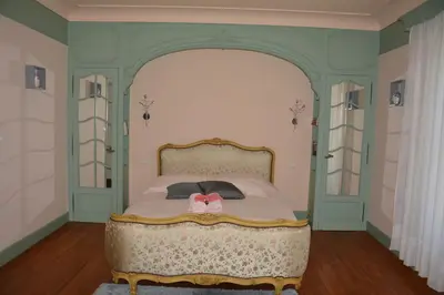 a bedroom with a bed with a pink bow on it at le lorrain in Saint-Pons