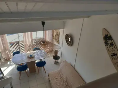 a living room with a couch and a table at T2 plage place parking in Port-la-Nouvelle