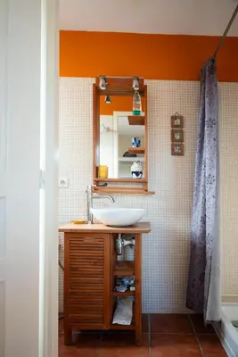 a bathroom with a sink and a mirror at Gîte Les Mathouans in Latour-de-France