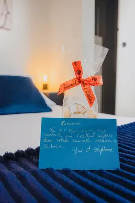 a bag of food sitting on top of a bed at 36 2 l air marin Penthouse Netflix Clim Free park Navette Grands Buffets Accès direct autoroute et plages in Narbonne