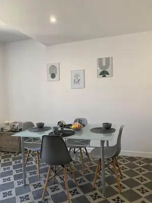 a dining room with two tables and chairs at Appartement cœur de village Numéro2 in Peyriac-de-Mer