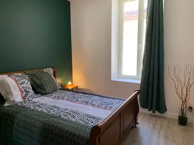 a bed sitting in a bedroom with a window at Appartement cœur de village Numéro2 in Peyriac-de-Mer