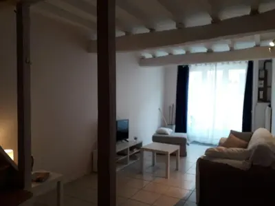 a living room with a couch and a table at gite au village in Mourvilles-Hautes