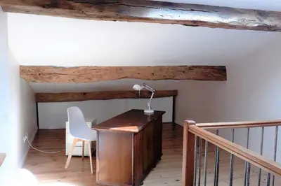 a room with a desk with a lamp and a chair at gite au village in Mourvilles-Hautes