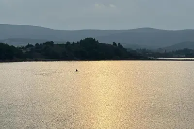 a boat in the middle of a large body of water at Grande villa de charme proche de la mer in Peyriac-de-Mer