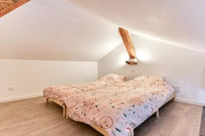 a bedroom with a bed in a attic at Grande villa de charme proche de la mer in Peyriac-de-Mer