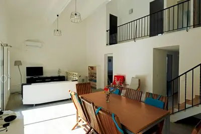 a dining room with a table and chairs at Maison confortable à 10 km des plages de la Méditerranée au bord du village pittoresque in Treilles