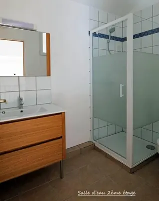 a bathroom with a glass shower and a sink at Maison confortable à 10 km des plages de la Méditerranée au bord du village pittoresque in Treilles