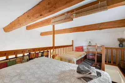 a bedroom with a bed and a couch in a room at Gîte vigneron in Félines-Minervois