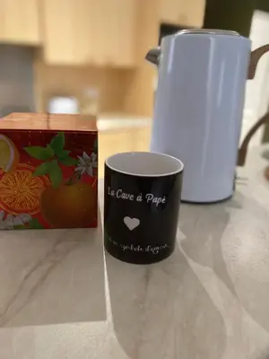 a coffee cup sitting on a counter next to a box at La cave à Papé in Peyriac-de-Mer