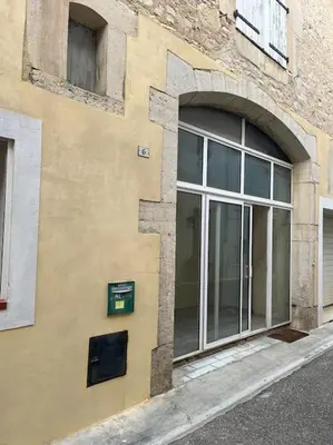 a building with a window on the side of it at La cave à Papé in Peyriac-de-Mer
