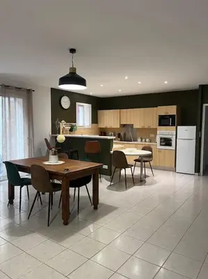 a kitchen and dining room with tables and chairs at La cave à Papé in Peyriac-de-Mer