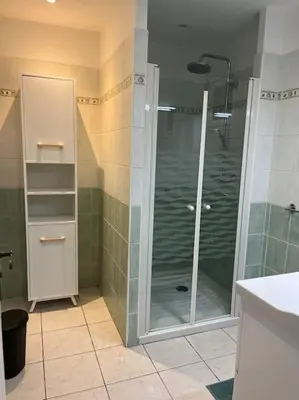 a bathroom with a shower with a glass door at La cave à Papé in Peyriac-de-Mer
