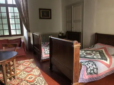 a room with three beds and a table and a table sidx sidx at château de Paulignan in Trausse