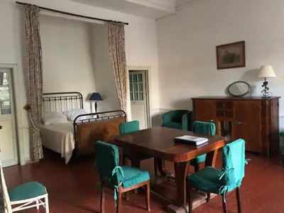 a room with a table and chairs and a bed at château de Paulignan in Trausse