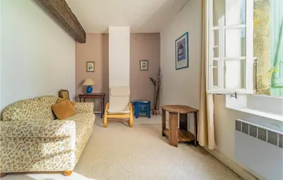 a living room with a couch and a table and a window at Nice Home In Chalabre With Wifi in Chalabre