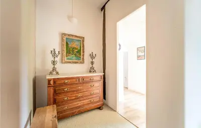 a room with a dresser and a painting on the wall at Nice Home In Chalabre With Wifi in Chalabre
