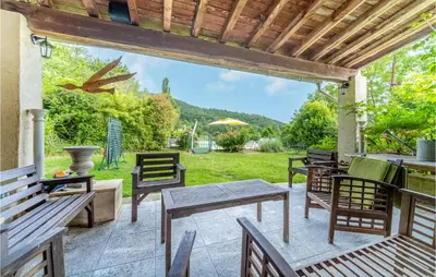 a patio with tables and chairs and a view of a field at Nice Home In Chalabre With Wifi in Chalabre