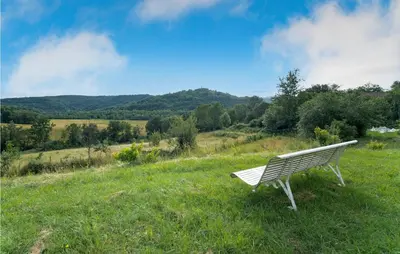 a white bench sitting in a field of grass at Nice Home In Chalabre With Wifi in Chalabre