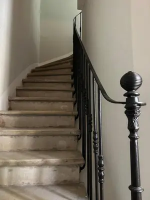 a set of stairs in a home with a black railing at Maison Paulette - charme et authenticité in Bizanet