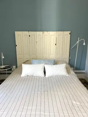 a bed with two pillows on it in a bedroom at Maison Paulette - charme et authenticité in Bizanet