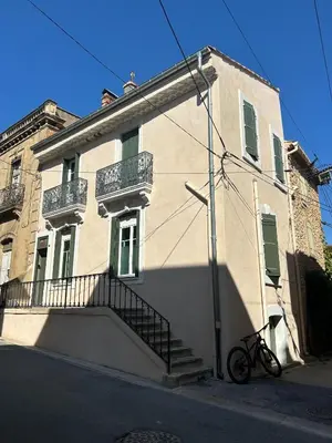 a bike parked in front of a building at Maison Paulette - charme et authenticité in Bizanet