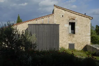 a stone building with a gate in front of it at TEMPS de PAUSE - CAMPAGNE in Lautrec