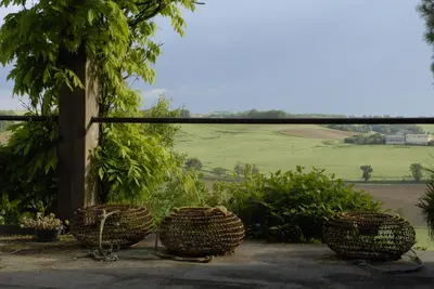 three baskets sitting on a patio with a view of a field at TEMPS de PAUSE - CAMPAGNE in Lautrec
