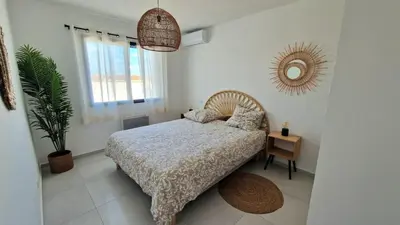 a bedroom with a bed and a mirror on the wall at L’Oliveraie in Narbonne