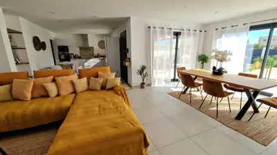 a living room with a couch and a table at L’Oliveraie in Narbonne