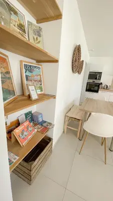 a small kitchen with a table and a chair at L’Oliveraie in Narbonne