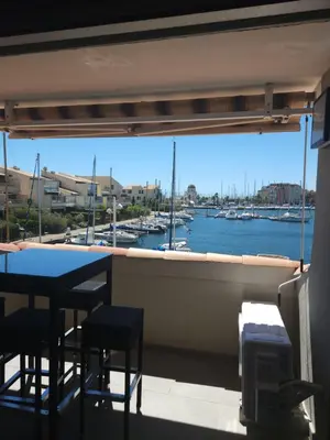a balcony with a view of a marina with boats at Confort sur le port in Gruissan