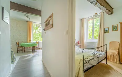 a bedroom with a bed and a dining room at 1 Bedroom Stunning Home In Chalabre in Chalabre