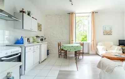 a kitchen with white cabinets and a table in a room at 1 Bedroom Stunning Home In Chalabre in Chalabre