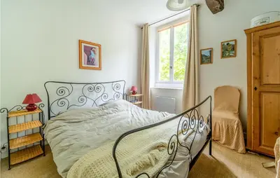 a bedroom with a bed and a window at 1 Bedroom Stunning Home In Chalabre in Chalabre