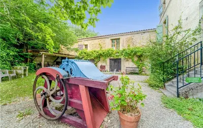 an old tractor sitting in the yard of a house at 1 Bedroom Stunning Home In Chalabre in Chalabre
