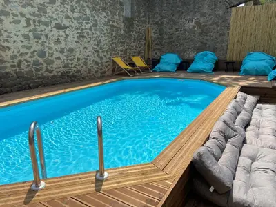 two beds in a attic room with wooden ceilings at T4 bord canal du midi, piscine in Homps