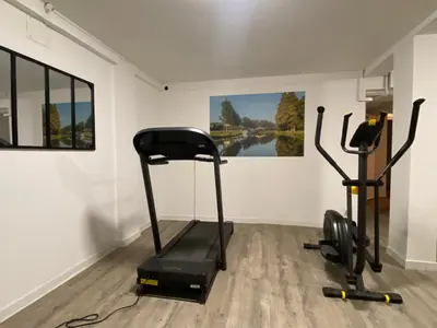 a gym with two exercise bikes in a room at T2 bord du canal du midi piscine in Homps
