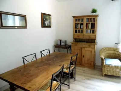 a dining room with a wooden table and chairs at Domaine du Bourdil au pays Cathare in Chalabre