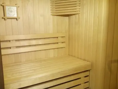 a sauna with wooden shelves and a clock at Domaine du Bourdil au pays Cathare in Chalabre