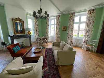 a living room with a couch and a table at Clos des Oliviers in Mirepoix