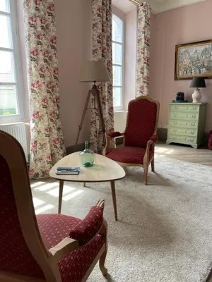 a living room with two chairs and a table at Clos des Oliviers in Mirepoix