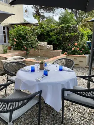 a table with a white table cloth on it at Clos des Oliviers in Mirepoix