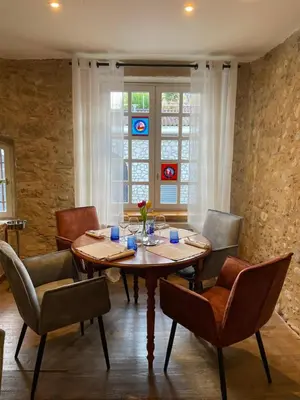a dining room with a wooden table and chairs at Clos des Oliviers in Mirepoix