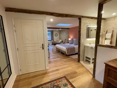 a bedroom with a bed and a bathroom at Clos des Oliviers in Mirepoix