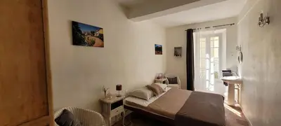 a bedroom with a bed in a room with a window at Comme à la Maison - Accueil tout Public - Groupes - Rando - Vélos - Motos in Saint-Paul-de-Fenouillet