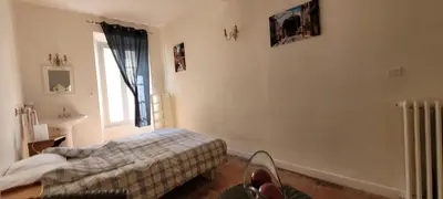 a bedroom with a bed and a window at Comme à la Maison - Accueil tout Public - Groupes - Rando - Vélos - Motos in Saint-Paul-de-Fenouillet